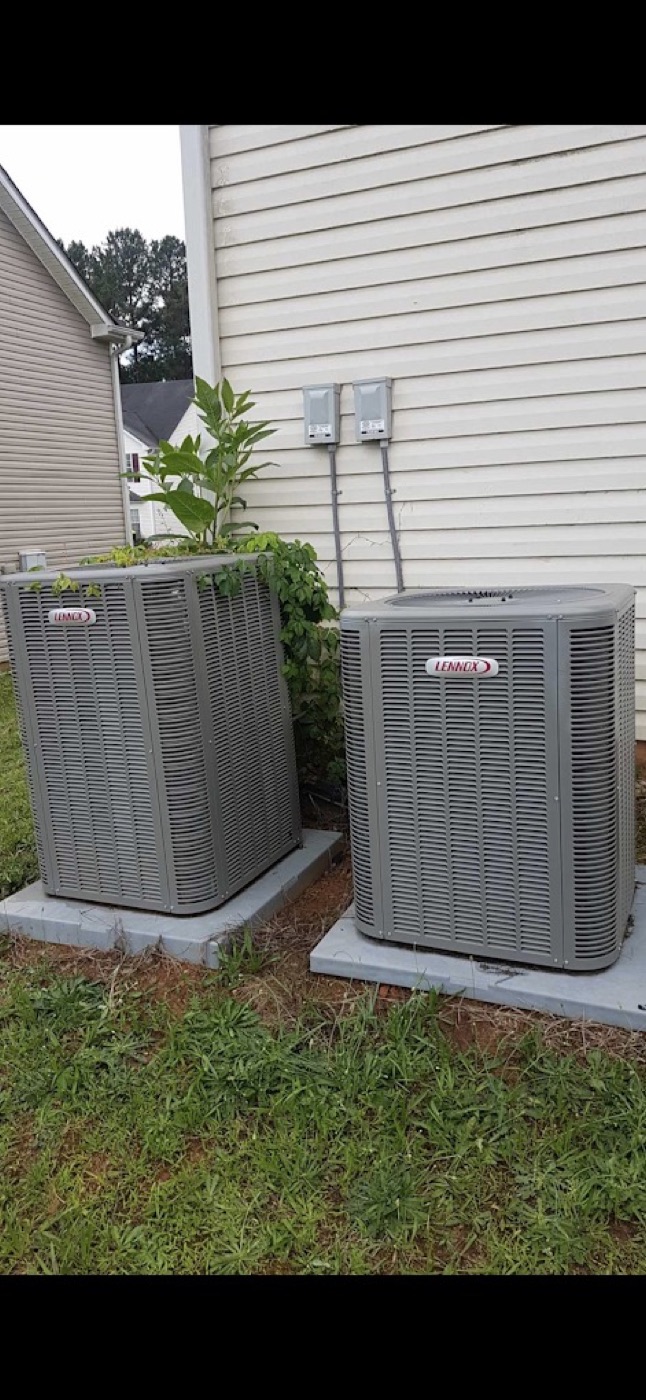 Two outdoor AC units side-by-side at a residential home installed by Dynasty